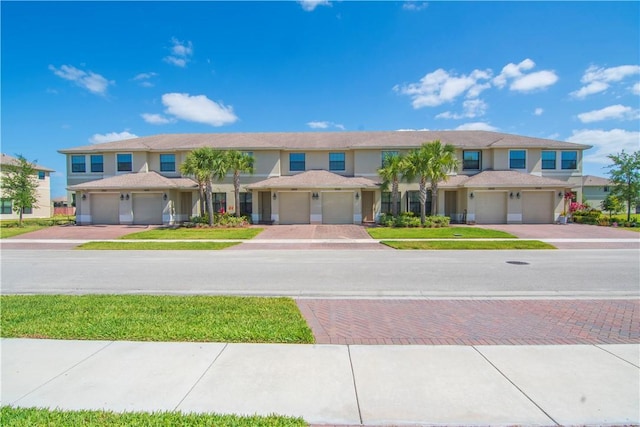 10008 W Villa Cir Unit 10008, Vero Beach, FL 32966 - view of property with a garage, stucco siding, and driveway