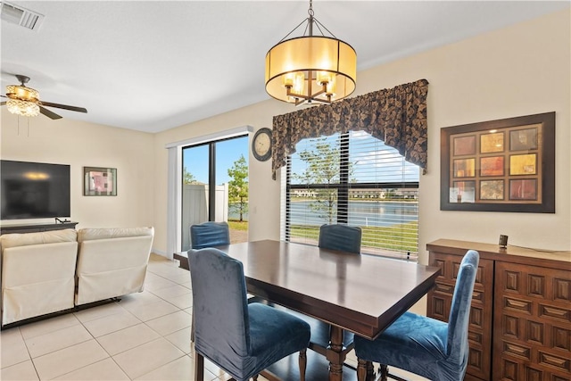 10008 W Villa Cir Unit 10008, Vero Beach, FL 32966 - dining area featuring light tile patterned flooring, visible vents, and ceiling fan with notable chandelier