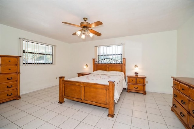 6001 Palm Dr, Fort Pierce, FL 34982 - bedroom with multiple windows, a ceiling fan, and light tile patterned floors