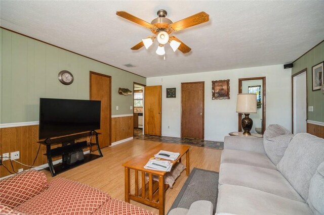 6001 Palm Dr, Fort Pierce, FL 34982 - living area with wood finished floors, ceiling fan, and wooden walls