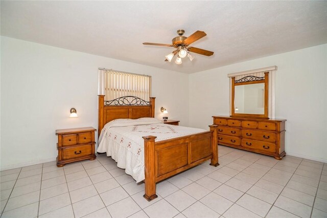 6001 Palm Dr, Fort Pierce, FL 34982 - bedroom featuring light tile patterned floors, a ceiling fan, and baseboards
