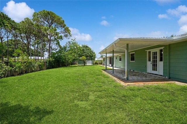 6001 Palm Dr, Fort Pierce, FL 34982 - view of yard featuring a patio area
