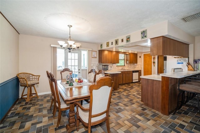 6001 Palm Dr, Fort Pierce, FL 34982 - dining room featuring a chandelier and plenty of natural light