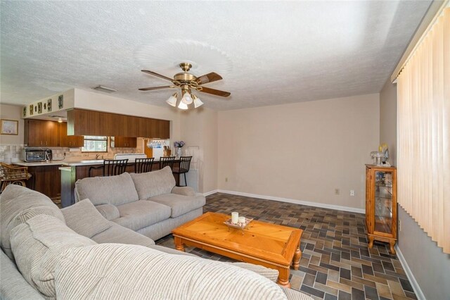 6001 Palm Dr, Fort Pierce, FL 34982 - living area featuring baseboards and ceiling fan