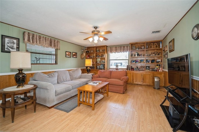 6001 Palm Dr, Fort Pierce, FL 34982 - living area featuring light wood-type flooring, plenty of natural light, ceiling fan, and wooden walls
