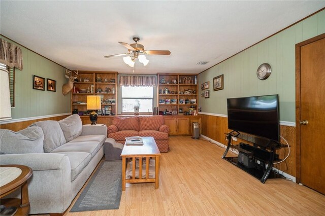6001 Palm Dr, Fort Pierce, FL 34982 - living area with light wood-type flooring, wood walls, and ceiling fan