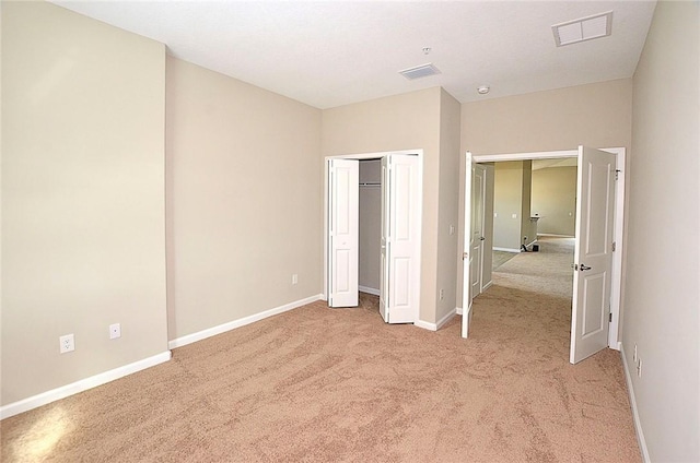 3951 Playa Del Sol Dr Unit 201, Rockledge, FL 32955 - unfurnished bedroom with baseboards, visible vents, light carpet, and a closet