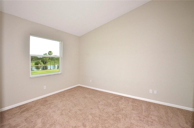 3951 Playa Del Sol Dr Unit 201, Rockledge, FL 32955 - carpeted spare room featuring baseboards and vaulted ceiling