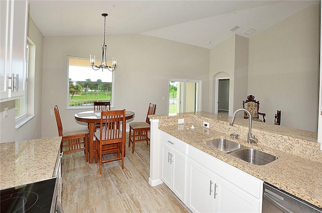 3951 Playa Del Sol Dr Unit 201, Rockledge, FL 32955 - kitchen featuring stainless steel dishwasher, lofted ceiling, light stone countertops, light wood-style floors, and a sink