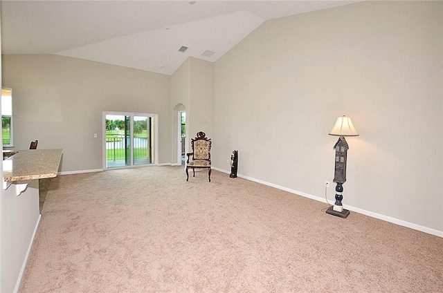 3951 Playa Del Sol Dr Unit 201, Rockledge, FL 32955 - unfurnished room with baseboards, carpet flooring, visible vents, and high vaulted ceiling