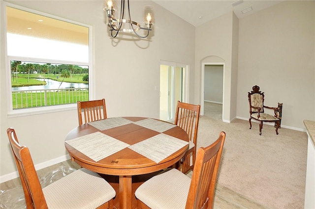 3951 Playa Del Sol Dr Unit 201, Rockledge, FL 32955 - dining space with vaulted ceiling, baseboards, a water view, and a chandelier