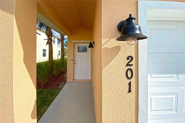 3951 Playa Del Sol Dr Unit 201, Rockledge, FL 32955 - doorway to property featuring stucco siding