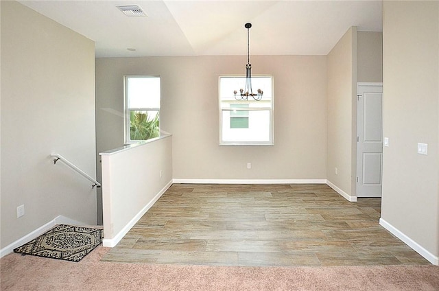 3951 Playa Del Sol Dr Unit 201, Rockledge, FL 32955 - interior space with an inviting chandelier, baseboards, wood finished floors, and visible vents