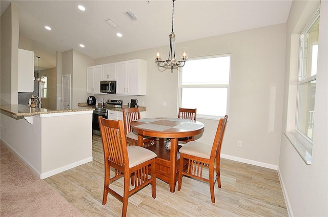 3951 Playa Del Sol Dr Unit 201, Rockledge, FL 32955 - dining space with a healthy amount of sunlight, visible vents, and a notable chandelier