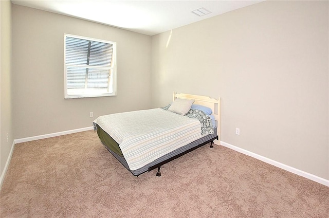 3951 Playa Del Sol Dr Unit 201, Rockledge, FL 32955 - bedroom featuring baseboards, carpet flooring, and visible vents
