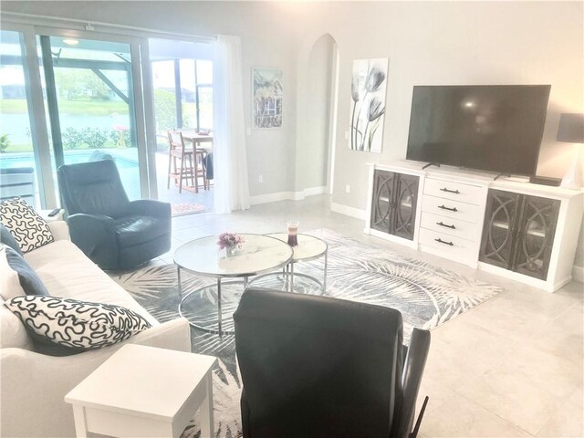 tiled living room featuring ceiling fan