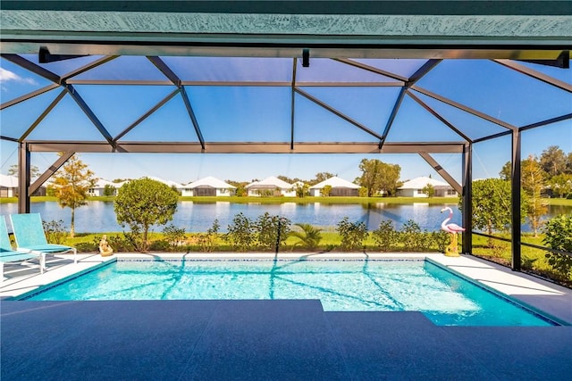 view of pool with glass enclosure and a water view