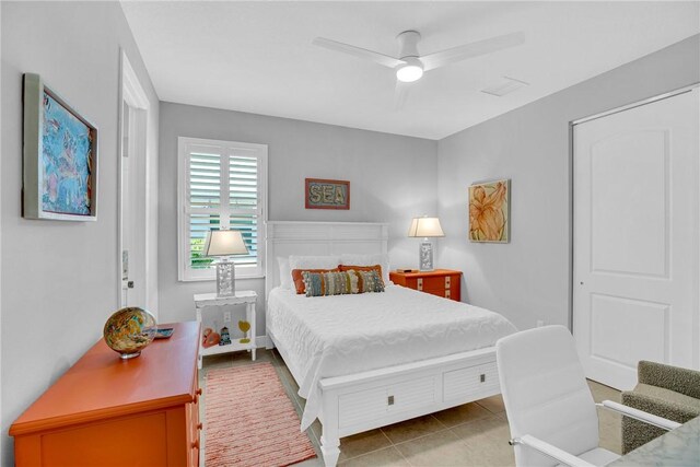 bedroom featuring tile patterned floors and ceiling fan