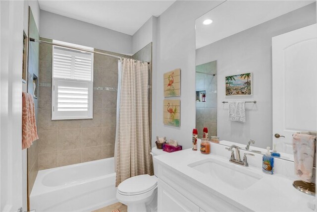 full bathroom featuring shower / bathtub combination with curtain, vanity, and toilet