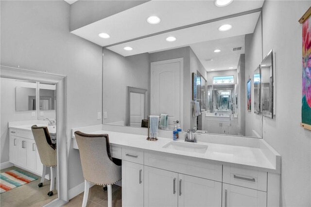 bathroom featuring tile patterned flooring and vanity