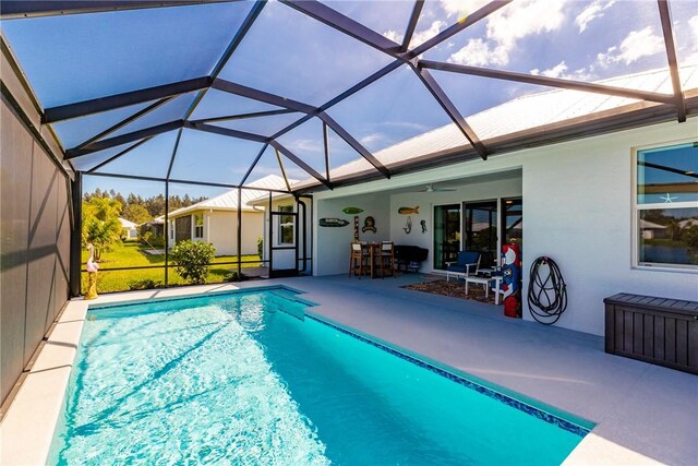 view of pool featuring an outdoor bar, ceiling fan, a lanai, and a patio area