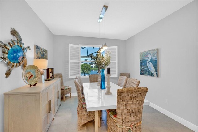 dining room featuring a skylight