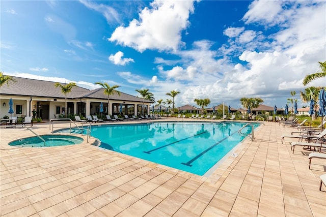 community pool with a patio and a community hot tub