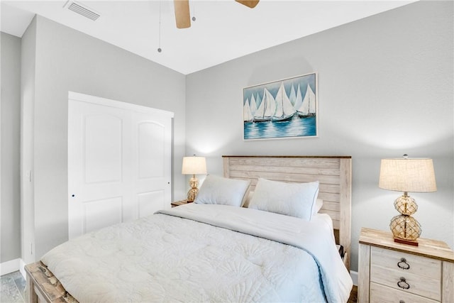 bedroom with baseboards, visible vents, and a ceiling fan