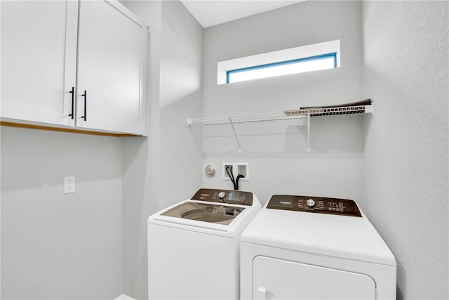 laundry area featuring washer and dryer and cabinet space