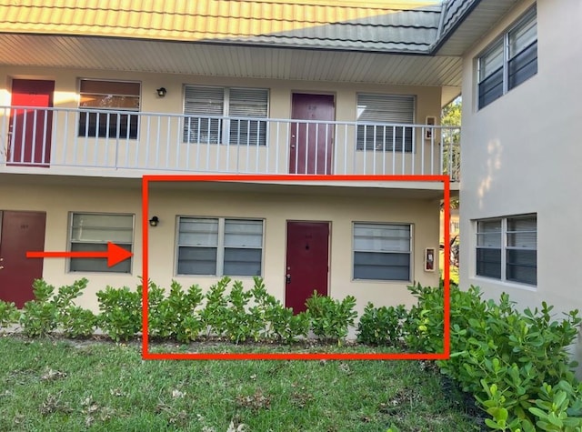 exterior space featuring a tile roof and stucco siding