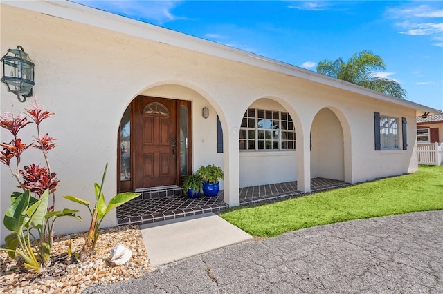 property entrance with a yard