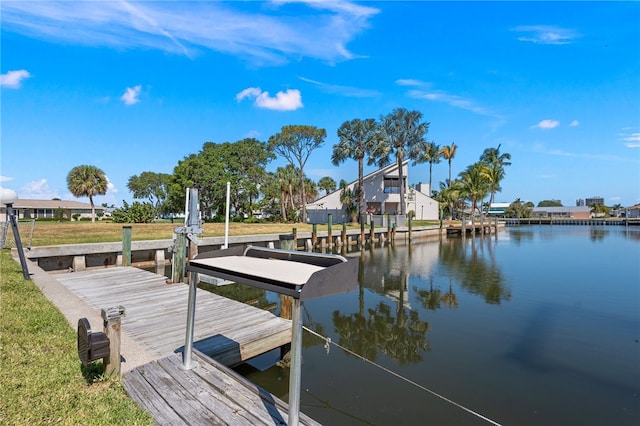 dock area featuring a yard and a water view