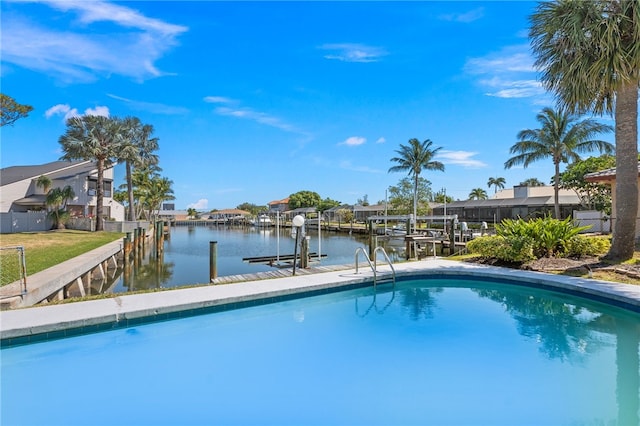 view of swimming pool featuring a dock and a water view