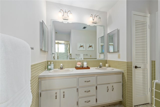 bathroom featuring vanity and tile walls