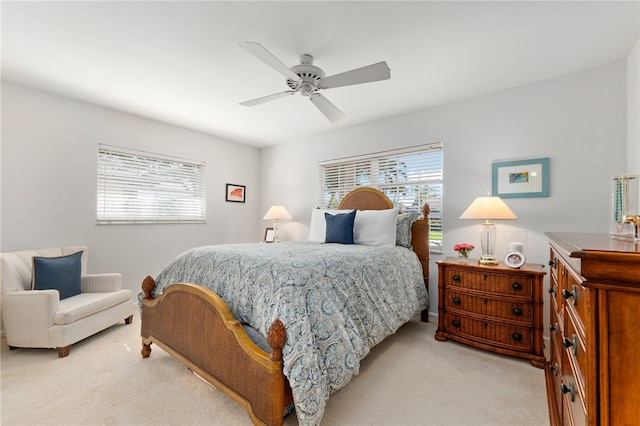 bedroom featuring ceiling fan and light carpet