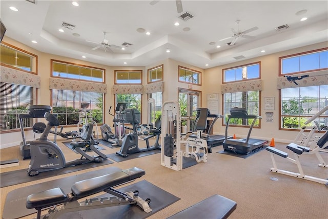 6341 Astor Pl, Vero Beach, FL 32966 - gym with ceiling fan, recessed lighting, a tray ceiling, baseboards, and a high ceiling