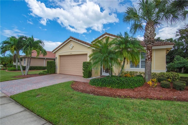 6341 Astor Pl, Vero Beach, FL 32966 - view of front of property featuring decorative driveway, stucco siding, a front yard, and a garage