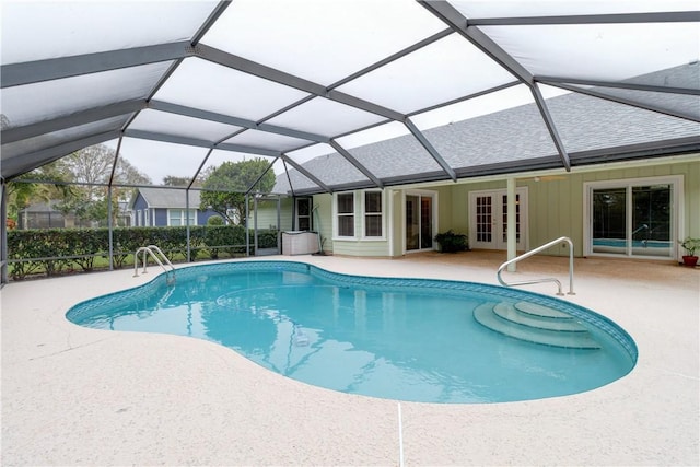 view of swimming pool featuring french doors, glass enclosure, and a patio area