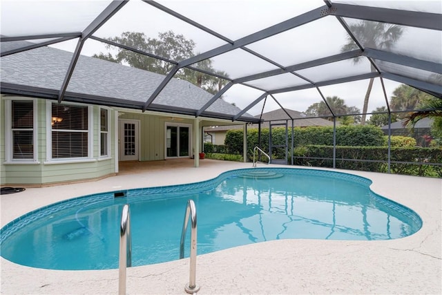 view of swimming pool featuring a patio area and glass enclosure