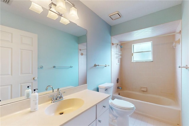 full bathroom featuring vanity, tiled shower / bath combo, and toilet