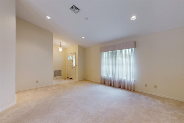 carpeted empty room with vaulted ceiling