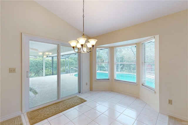 tiled dining area with lofted ceiling and an inviting chandelier