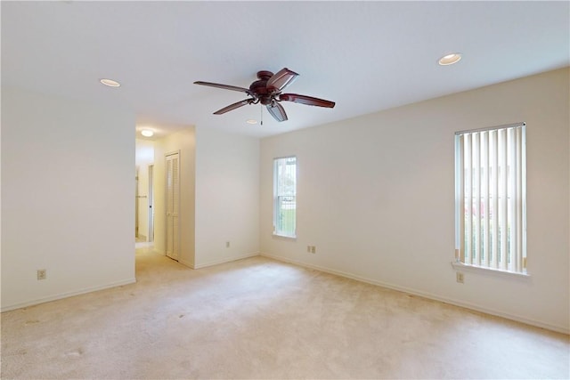 carpeted empty room featuring ceiling fan