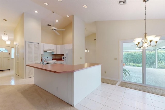 kitchen featuring light tile patterned flooring, a center island with sink, pendant lighting, white appliances, and white cabinets