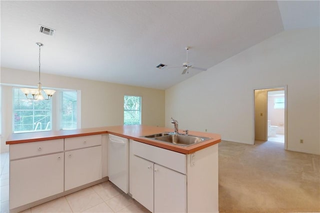 kitchen with vaulted ceiling, white dishwasher, sink, and white cabinets