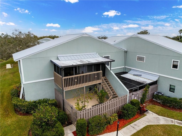 back of property featuring a sunroom