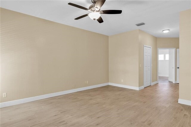 spare room with ceiling fan and light wood-type flooring