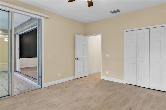 unfurnished bedroom featuring ceiling fan, a closet, and light wood-type flooring