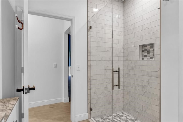 bathroom with vanity, wood-type flooring, and an enclosed shower