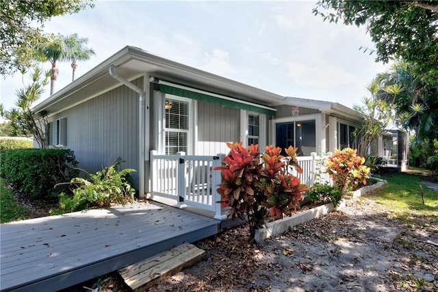 view of side of property featuring a deck